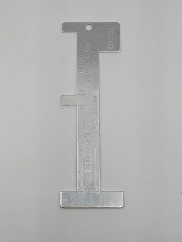Close-up of combination fish gauge showing engraved measurements for Crab, Cray and Abalone
