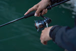 Angler fishing with Shimano Nasci FD reel on a spinning rod inshore.