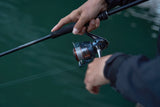 Angler fishing with Shimano Nasci FD reel on a spinning rod inshore.