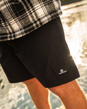 Black 18 inch swim volley shorts with elastic drawcord waistband, side and back pockets, lightweight stretch fabric, and clean minimal design
