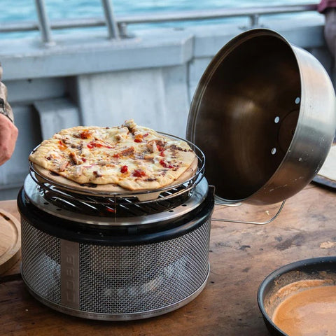 Fresh pizza cooking on COBB Pizza Stone outdoors