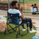 GCI Outdoor Freestyle Rocker Elite folding camping chair with mesh backrest, padded armrests, beverage holder and rocking frame.