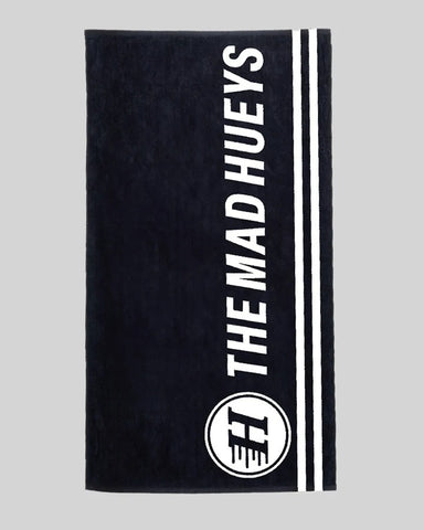 Mad Hueys Beach Towel made from 100% cotton with classic front print and woven Hueys label — perfect for beach, pool, or coastal adventures.