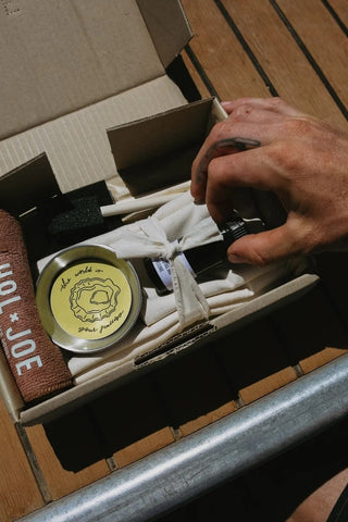 angler applying paint to a fish before pressing onto paper for a Gyotaku print.